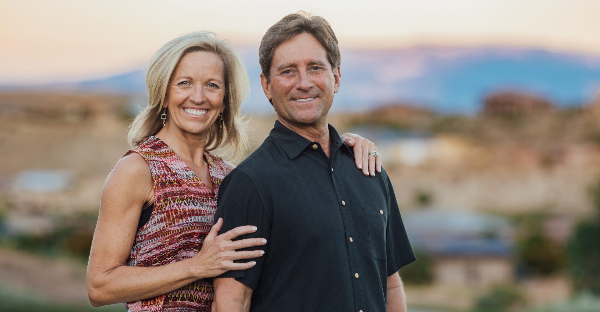 A woman leading a meeting with four team members applauding