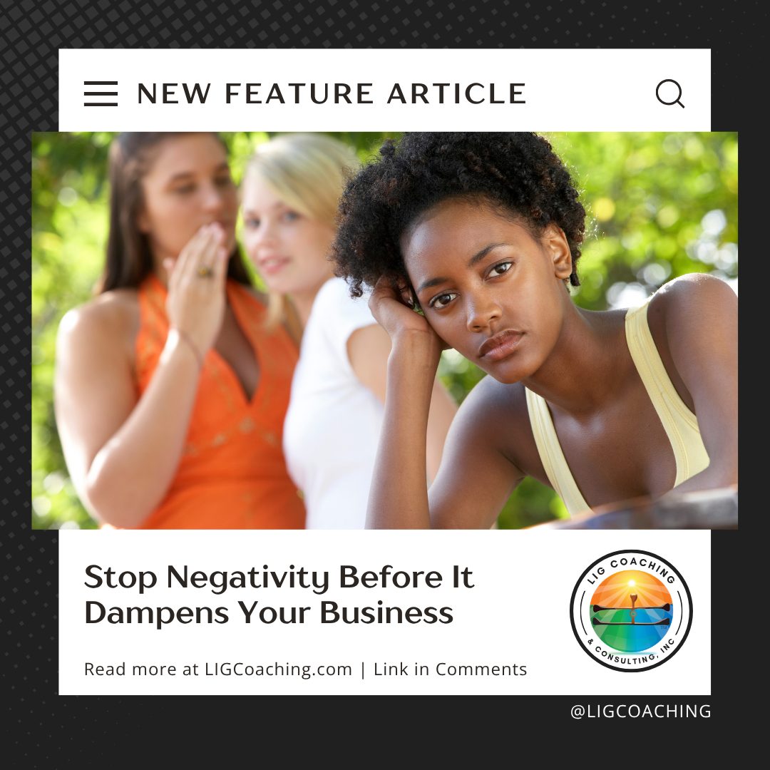 Employee sitting apart looking discouraged while two coworkers whisper in the background, illustrating the damaging effects of workplace negativity, gossip, and toxic team culture.